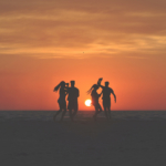 dancers in silhouette against the sunset